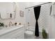 Stylish bathroom showcasing a tub, shower combo with marble tile, modern fixtures and white vanity at 1014 Alamo St, North Charleston, SC 29405
