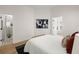 Bright bedroom featuring hardwood floors, modern decor, and a bathroom ensuite with glass enclosed shower at 1014 Alamo St, North Charleston, SC 29405