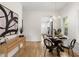 Bright dining room featuring a round glass table and modern lighting fixtures leading into kitchen at 1014 Alamo St, North Charleston, SC 29405