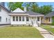 Charming single-story home featuring a well-manicured lawn, a pastel-painted front door, and a cozy front porch at 1014 Alamo St, North Charleston, SC 29405