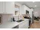 This spacious kitchen features white cabinetry, stainless steel appliances, and quartz countertops at 1014 Alamo St, North Charleston, SC 29405