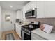 Modern kitchen with stainless steel appliances, white cabinetry, and a bright view to the backyard at 1014 Alamo St, North Charleston, SC 29405