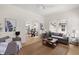 Open-concept living room seamlessly connects to the dining area, offering hardwood floors and neutral walls at 1014 Alamo St, North Charleston, SC 29405
