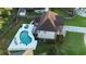 Aerial view of a backyard with a pool, patio, outdoor seating, and well-maintained landscaping at 102 Six Point Ct, Goose Creek, SC 29445
