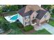 Stunning aerial view of a brick two-story home with a sparkling pool and manicured landscaping at 102 Six Point Ct, Goose Creek, SC 29445