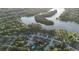 Beautiful aerial view of lakefront homes surrounded by mature trees and manicured lawns at 102 Six Point Ct, Goose Creek, SC 29445