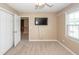 Inviting bedroom with carpet, neutral walls, natural light, and mounted TV at 102 Six Point Ct, Goose Creek, SC 29445