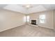Spacious bedroom featuring a fireplace, plush carpet, and tray ceiling with fan at 102 Six Point Ct, Goose Creek, SC 29445