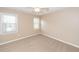 A bright bedroom is shown with two windows offering natural light and neutral walls at 102 Six Point Ct, Goose Creek, SC 29445