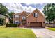 Beautiful brick home with attached garage, manicured lawn, and lovely flower boxes at 102 Six Point Ct, Goose Creek, SC 29445