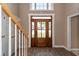 Bright foyer featuring hardwood floors, natural light, and a grand wooden front door at 102 Six Point Ct, Goose Creek, SC 29445