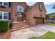 Close up of the home's brick facade, showing the front door, landscaping, and the garage at 102 Six Point Ct, Goose Creek, SC 29445
