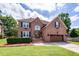 Charming two-story brick home with manicured lawn, flower boxes, and a two-car garage at 102 Six Point Ct, Goose Creek, SC 29445