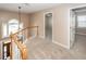 Well-lit carpeted hallway with an open view of the home's entry and second-floor landing at 102 Six Point Ct, Goose Creek, SC 29445