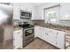 Updated kitchen featuring stainless appliances, granite countertops, and tile backsplash at 102 Six Point Ct, Goose Creek, SC 29445