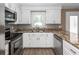 Well-lit kitchen with stainless steel appliances, granite countertops, and white cabinetry at 102 Six Point Ct, Goose Creek, SC 29445