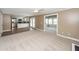 Open-concept living room with hardwood and carpet, flowing into the kitchen and sunroom at 102 Six Point Ct, Goose Creek, SC 29445