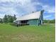 Community barn with green facade, a bright metal roof and a well-manicured green lawn at 105 Archdale St, Summerville, SC 29486