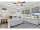 Sunlit bedroom features multiple windows, a ceiling fan, and stylish decor for a relaxing retreat at 105 Archdale St, Summerville, SC 29486