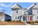 Well-maintained two-story home featuring gray siding and landscaping with colorful doors at 105 Archdale St, Summerville, SC 29486