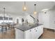 Open kitchen with a large island, granite countertops, and stylish pendant lighting at 105 Archdale St, Summerville, SC 29486