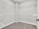 Spacious walk-in closet features carpeted floors and ample shelving, offering plenty of storage at 105 Archdale St, Summerville, SC 29486