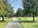 Picturesque walking path surrounded by lush greenery, perfect for a peaceful stroll at 105 Archdale St, Summerville, SC 29486
