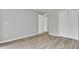 Bright bedroom features light gray walls, wood-look flooring, and closet space at 108 Greenmeadow Dr, Goose Creek, SC 29445