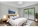 Comfortable bedroom with neutral tones, a cozy bed, bedside tables, and a sliding door to an outdoor balcony at 108 Greenmeadow Dr, Goose Creek, SC 29445