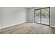 A light, airy bedroom featuring wood floors and sliding glass doors to a deck or balcony at 108 Greenmeadow Dr, Goose Creek, SC 29445