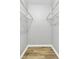 Walk-in closet with wire shelving and wood-look flooring at 108 Greenmeadow Dr, Goose Creek, SC 29445