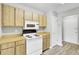 Efficient kitchen featuring wood cabinets, white appliances, and laminate flooring, offering a practical cooking space at 108 Greenmeadow Dr, Goose Creek, SC 29445