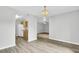 Open living room featuring modern floors, neutral walls, and an elegant chandelier creating an inviting atmosphere at 108 Greenmeadow Dr, Goose Creek, SC 29445