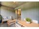 Charming outdoor patio with comfortable seating, a wooden table, and a view through the sliding glass doors at 108 Greenmeadow Dr, Goose Creek, SC 29445