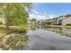 View of serene pond reflecting nearby buildings, creating a tranquil atmosphere in this community at 108 Greenmeadow Dr, Goose Creek, SC 29445