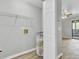 Well-organized utility room with a water heater, shelving, and nearby access to the back patio at 108 Greenmeadow Dr, Goose Creek, SC 29445