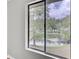 A window provides a beautiful view of the lush green landscape and tranquil pond outside at 108 Greenmeadow Dr, Goose Creek, SC 29445