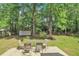 Lush backyard with mature trees, an outdoor table, and a tranquil setting for relaxation at 109 Williams Ct, Goose Creek, SC 29445