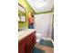 Bright bathroom with a wood vanity, speckled granite countertop, and decorative shower curtain at 109 Williams Ct, Goose Creek, SC 29445