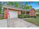 Single-story brick home with an attached garage, and a well-manicured lawn and driveway at 109 Williams Ct, Goose Creek, SC 29445