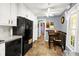 An eat-in kitchen features a dining table set, white cabinets, and black appliances at 109 Williams Ct, Goose Creek, SC 29445