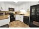 Well-lit kitchen showcasing white cabinets, black appliances, granite countertops, and tile flooring at 109 Williams Ct, Goose Creek, SC 29445