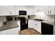 Close up of the kitchen featuring white cabinets, granite countertops, and black appliances at 109 Williams Ct, Goose Creek, SC 29445