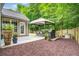 Outdoor patio area with seating, a grill, and lush landscaping at 113 Ashton Cv, Summerville, SC 29485