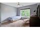 Cozy bedroom with a bed, window, ceiling fan, and a quaint chair with a faux fur throw at 113 Ashton Cv, Summerville, SC 29485