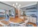Open-concept dining room featuring hardwood floors, chandelier, and seamless flow to other living areas at 113 Ashton Cv, Summerville, SC 29485