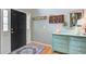 Charming entryway showcases a black front door, hardwood floors, and a light-blue decorative dresser at 113 Ashton Cv, Summerville, SC 29485
