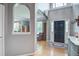 Bright and airy entryway features hardwood floors, a black front door, and an arched doorway at 113 Ashton Cv, Summerville, SC 29485