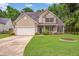 Charming two-story home with a well-manicured lawn and attached two-car garage at 113 Ashton Cv, Summerville, SC 29485