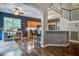 Inviting living room featuring a bar, wood floors, and an open layout to the kitchen and staircase at 113 Ashton Cv, Summerville, SC 29485